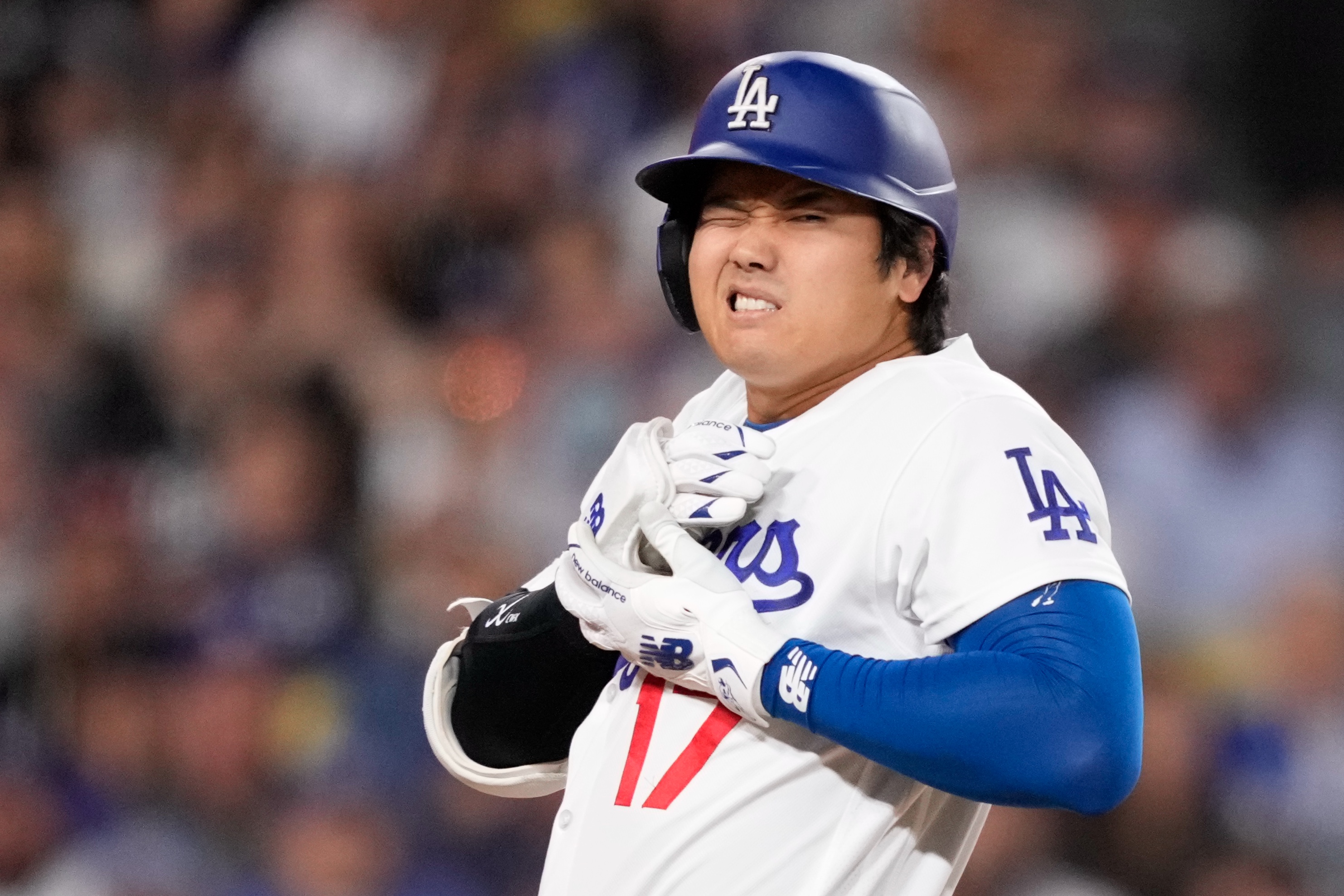 Los Angeles Dodgers' Shohei Ohtani reacts after being hit by a pitch during the fourth inning of a baseball game against the Colorado Rockies, Tuesday, May 26, 2026, in Los Angeles.