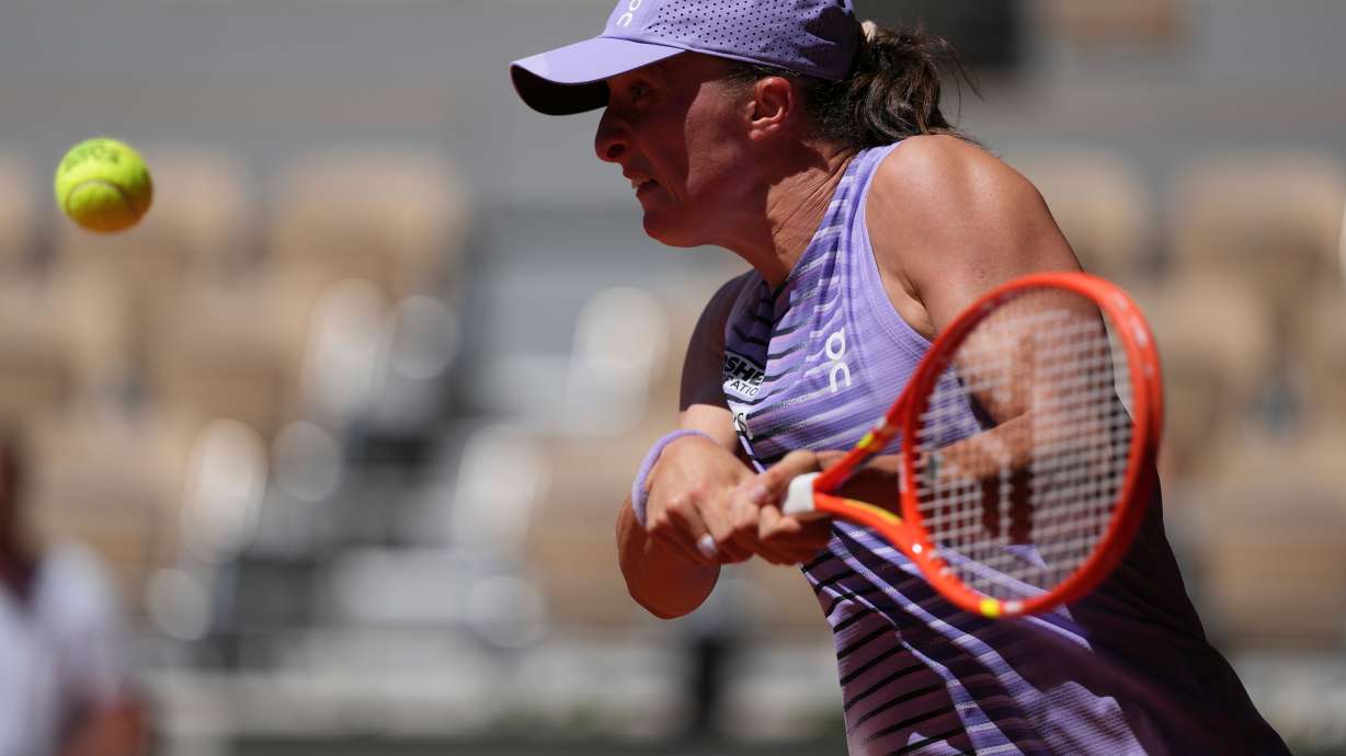 Iga Swiatek of Poland returns to Sara Bejlek of the Czech Republic during their second round women's singles tennis match at the French Open tennis tournament in Paris, Wednesday, May 27, 2026.