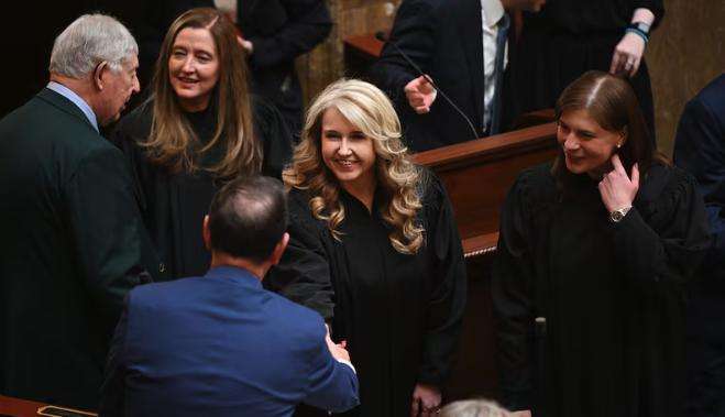 Rep. Norman K. Thurston, R-Provo, shakes hands with Justice Diana Hagen, as members of Utah’s Supreme Court arrive ahead of Chief Justice Matthew B. Durrant, speaking to a joint session of the Utah Legislature inside the House of Representatives at the Capitol in Salt Lake City on Jan. 21, 2025.
