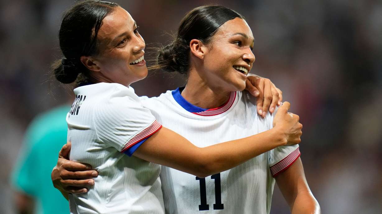FILE - United States' Mallory Swanson, left, reacts with teammate Sophia Smith after scoring her side's third goal during a women's group B match between the United States and Zambia at Nice Stadium at the 2024 Summer Olympics, July 25, 2024, in Nice, France.