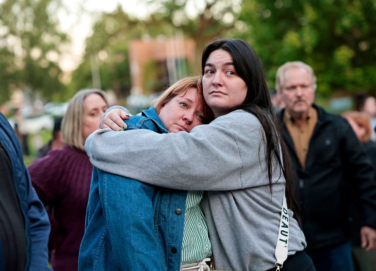 Diana Winther and Kellie Webber embrace in a hug during an evening prayer and vigil in support for the victims and their families impacted by Nippon Dynawave Packaging Co. tank implosion, at R.A. Long Park in Longview, Wash., on Tuesday. Authorities said Wednesday a second person had died from their injuries, bringing the presumed toll to 11.