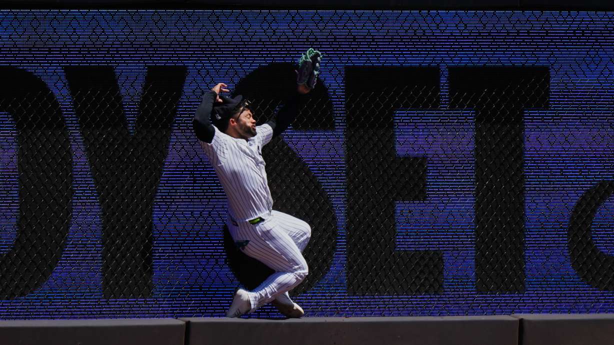 New York Yankees' Jasson Domínguez is injured while catching a ball hit by Texas Rangers' Brandon Nimmo for an out during the first inning of a baseball game Thursday, May 7, 2026, in New York.