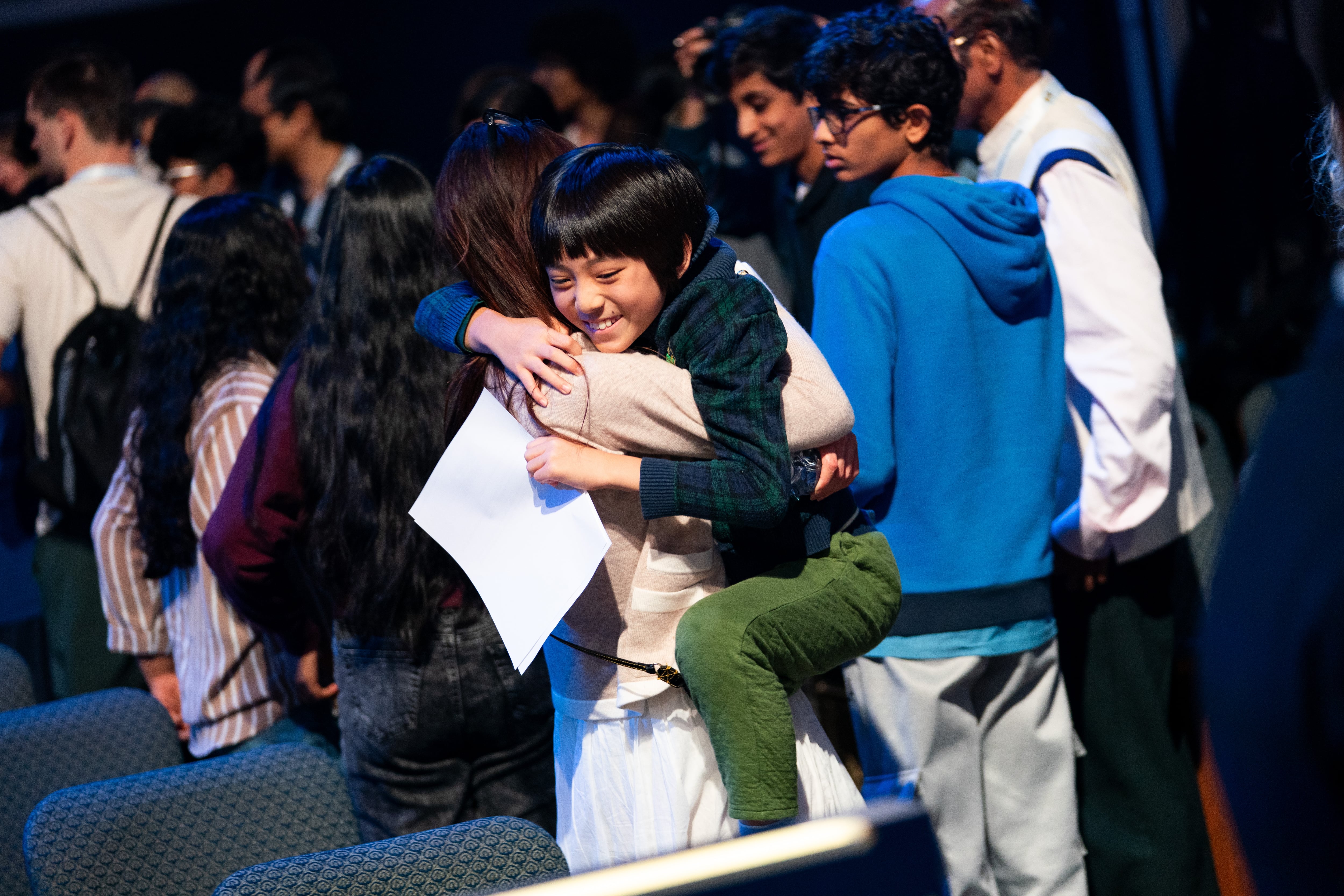 Zachary Teoh, 9, of Houston, Texas, hugs his mother after making it to the semifinals of the Scripps National Spelling Bee, Wednesday, in Washington. The finals are scheduled to take place Thursday.