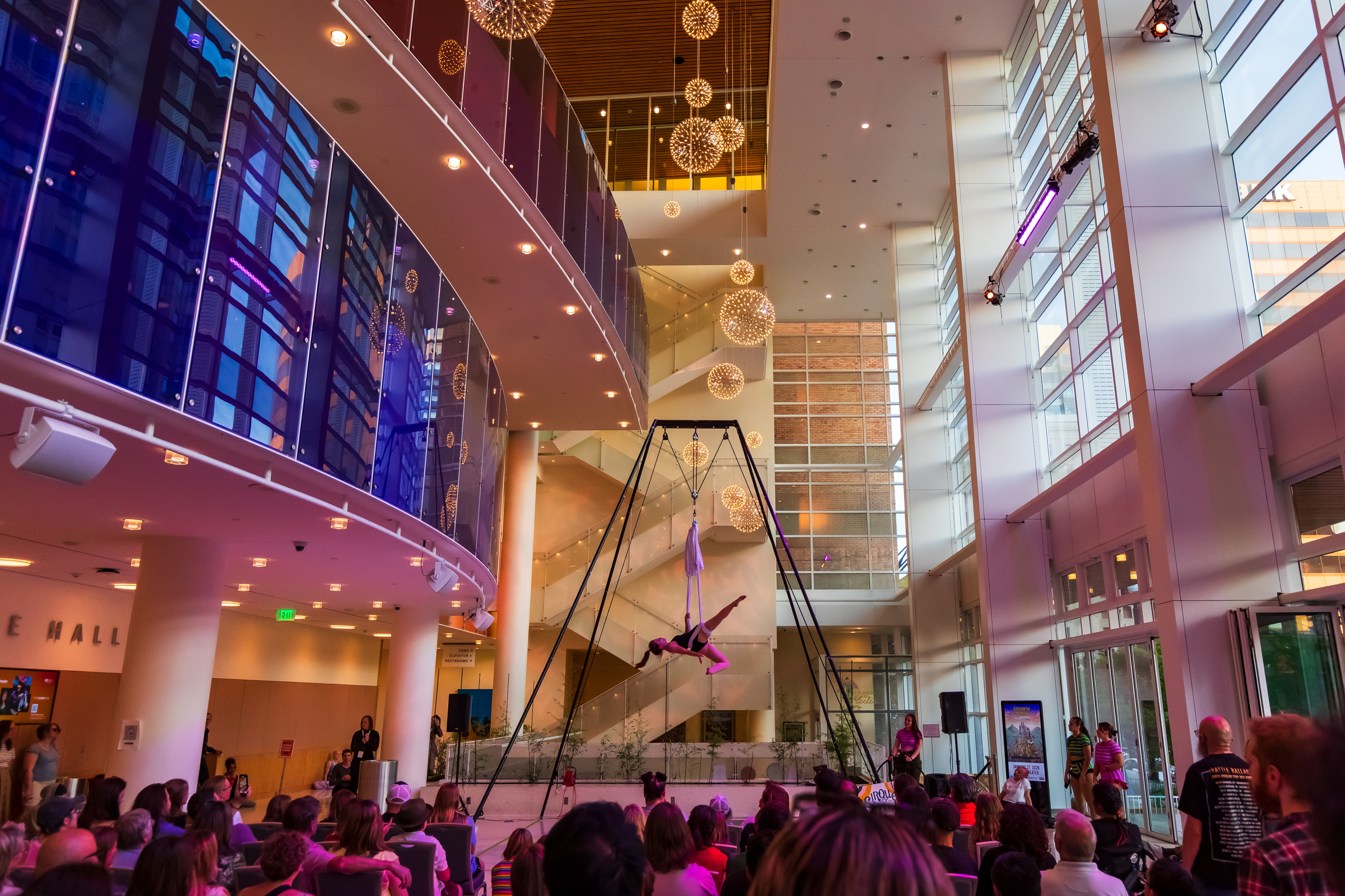 An audience watches as a member of Cirque du Salt Lake performs at a Busker Fest inside the lobby of the Eccles Theater on May 30, 2025. Busker Fest returns this Friday and Saturday, but questions now loom about its future beyond this weekend after proposed budget cuts.