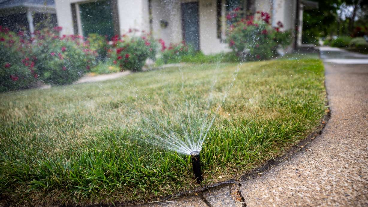 Sprinklers spray water on a lawn in the Avenues in Salt Lake City on Tuesday. After a warm and dry winter, concern about water and the Great Salt Lake has reached new heights, according to a new Deseret News poll.