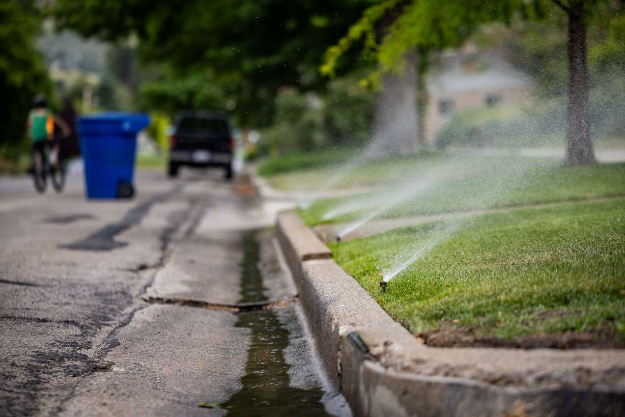 Sprinklers spray water on a lawn in the Avenues in Salt Lake City on Tuesday. Lawmakers have proposed several options for enforcing water restrictions this summer.