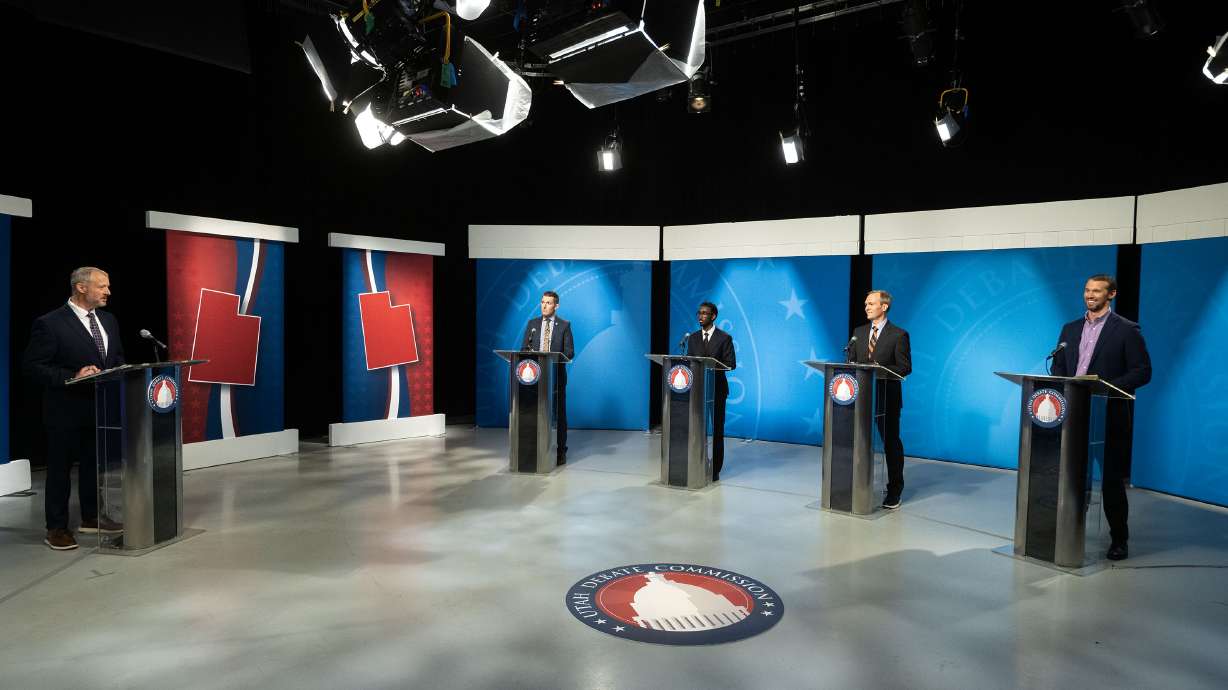 Moderator Max Roth speaks to candidates Nate Blouin, Liban Mohamed, Ben McAdams and Michael Farrell before the 1st Congressional District Democratic primary debate at the Eccles Broadcast Center in Salt Lake City on Wednesday.