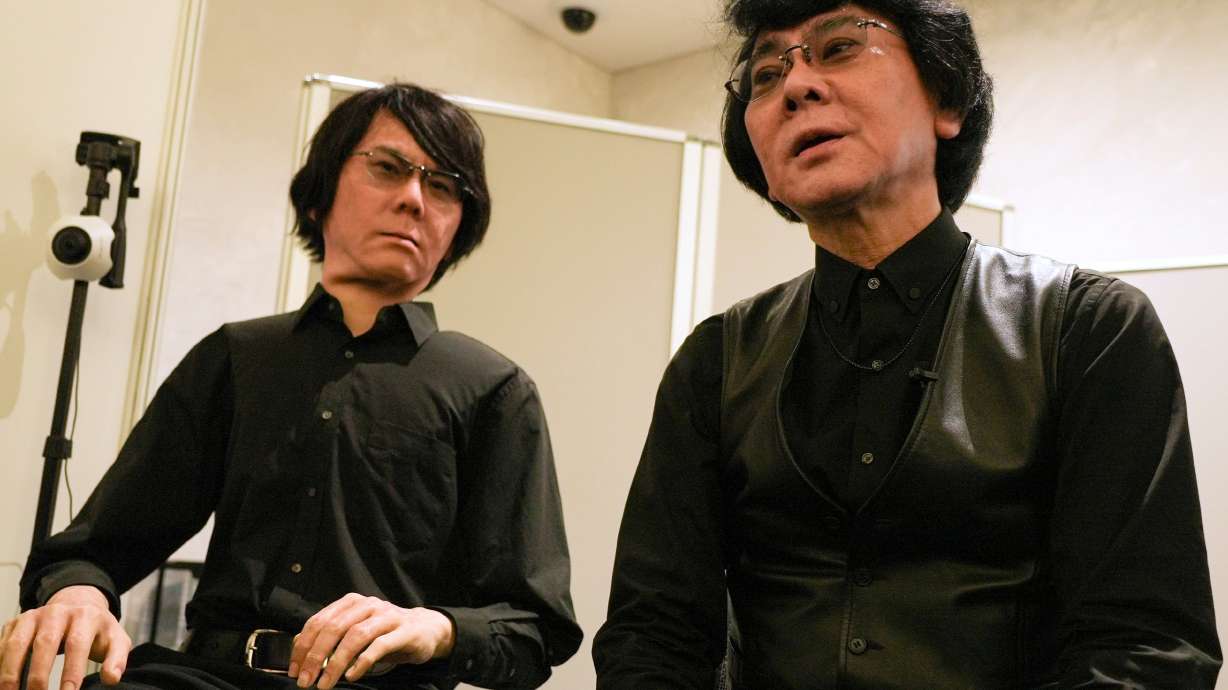 Professor Hiroshi Ishiguro, right, of Osaka University talks to android robot Geminoid at the Humanoids Summit 2026 in Tokyo, Thursday.