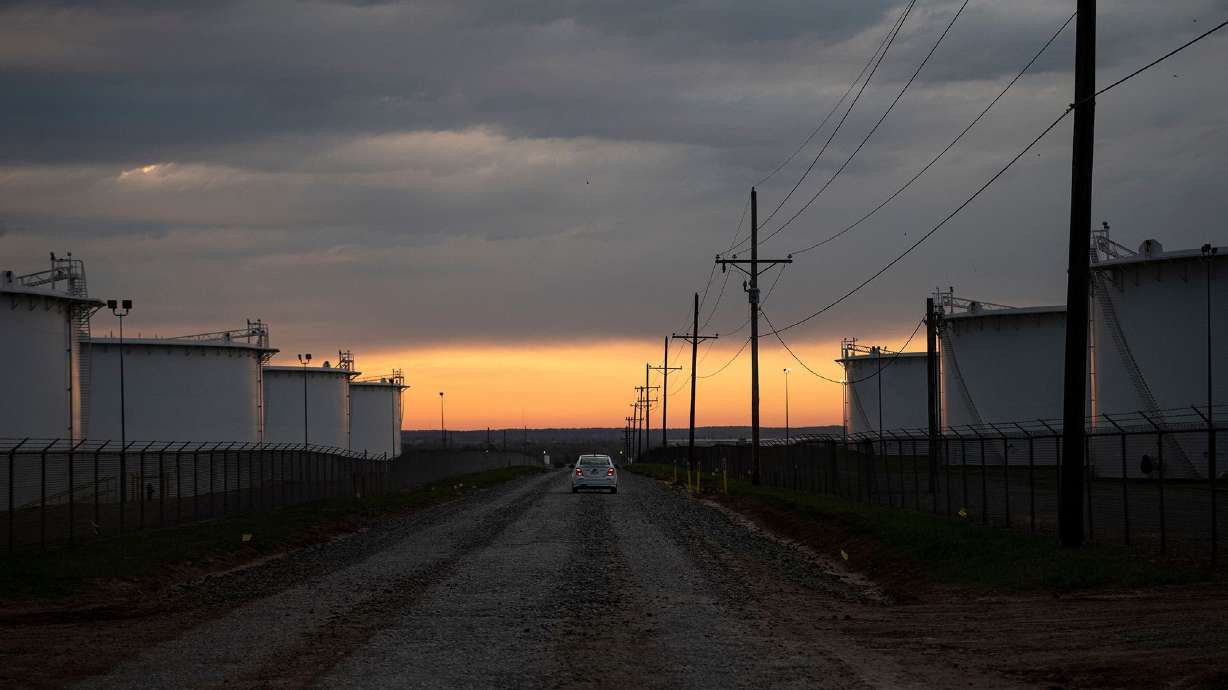 The sun rises behind a crude oil storage facility on May 5, 2020, in Cushing, Oklahoma. President Trump is draining the nation's emergency oil stockpile at an even faster pace than Joe Biden is ahead of this year's midterms.