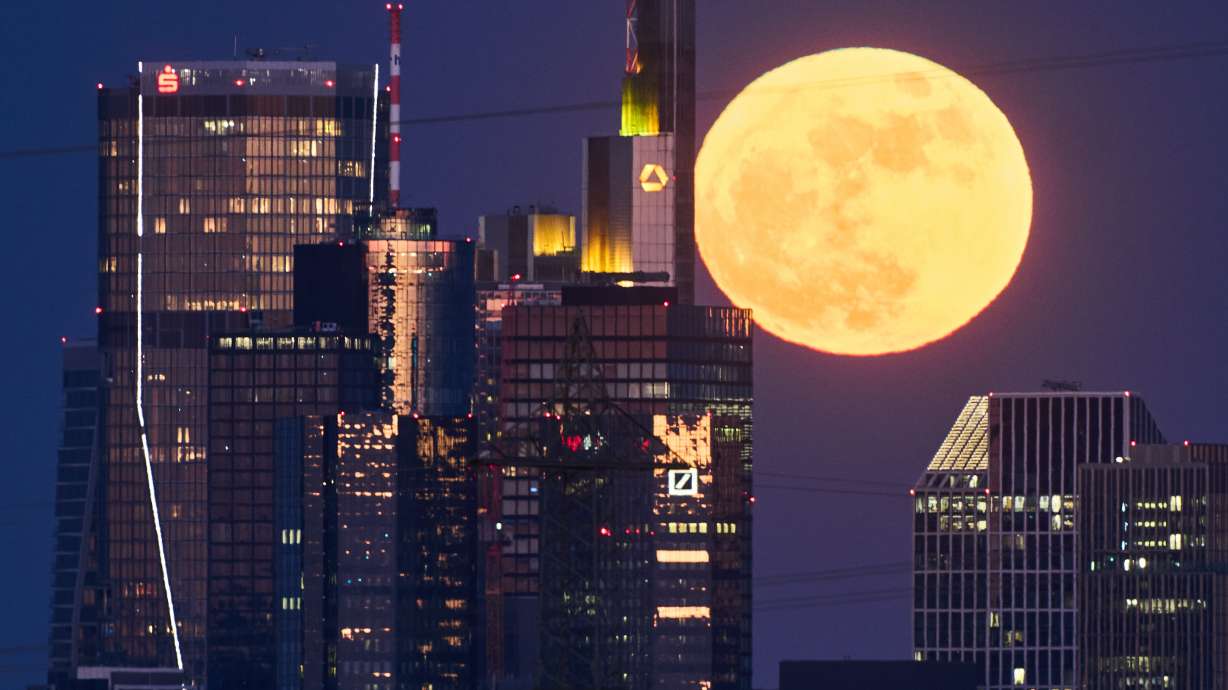 The full moon rises above the banking district in Frankfurt, Germany, May 1. Get set for a rare blue micromoon this weekend — a blue moon that's also the most distant and smallest-looking full moon of the year.