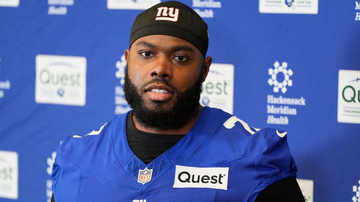 FILE - New York Giants' Andrew Thomas speaks to reporters after NFL football practice in East Rutherford, N.J., May 21, 2026.