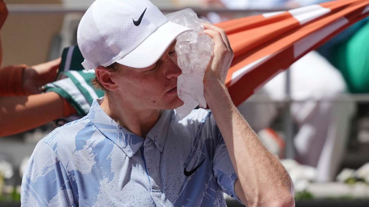 Jannik Sinner of Italy cools himself with the ice during the second round men's singles tennis match against Juan Manuel Cerundolo of Argentina at the French Open tennis tournament in Paris, Thursday, May 28, 2026.