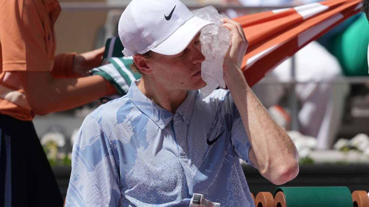 Jannik Sinner of Italy cools himself with the ice during the second round men's singles tennis match against Juan Manuel Cerundolo of Argentina at the French Open tennis tournament in Paris, Thursday, May 28, 2026.