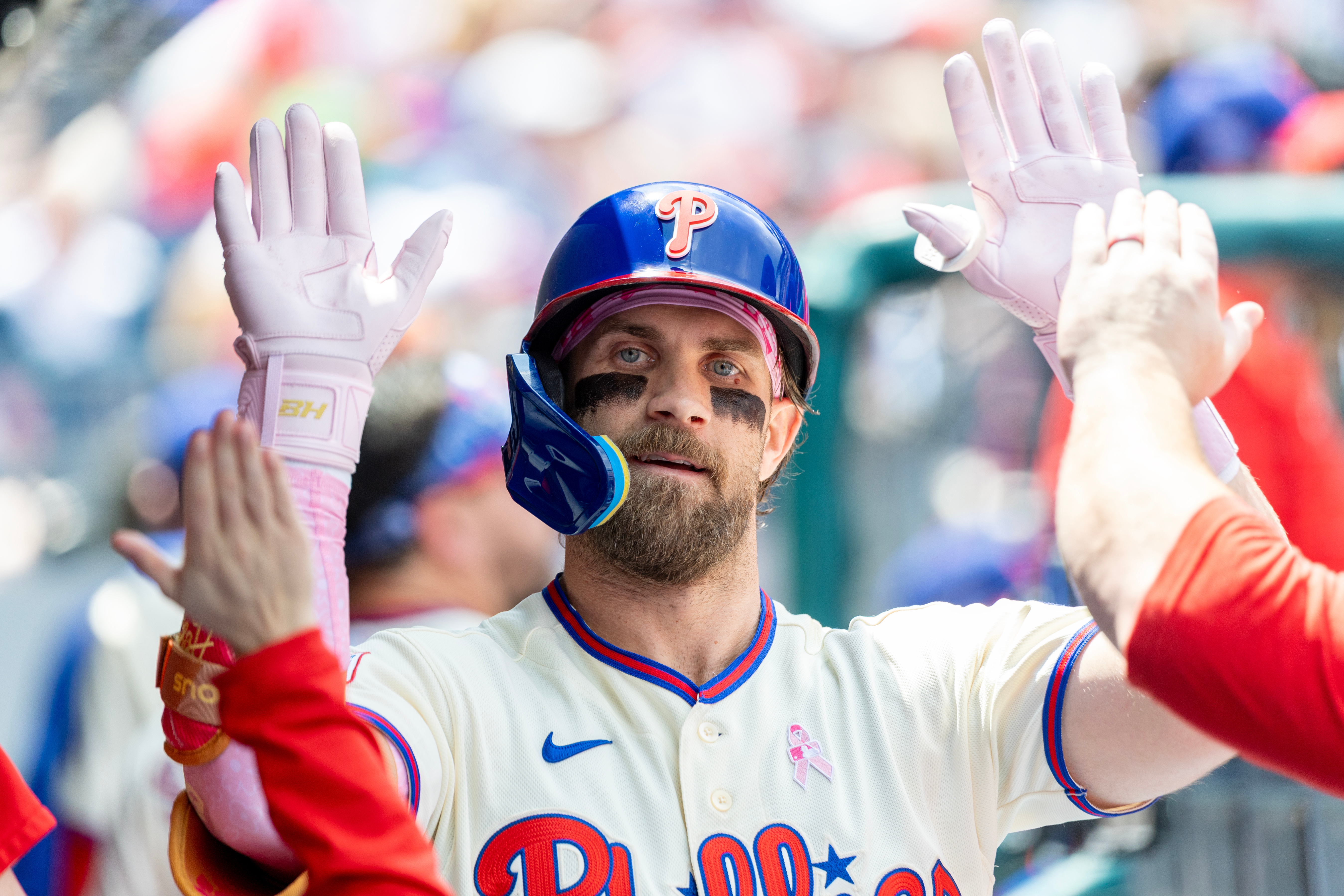 Philadelphia Phillies' Bryce Harper is congratulated in the dugout after he hit a solo home run in the first inning of a baseball game against the Colorado Rockies, Sunday, May 10, 2026, in Philadelphia. 