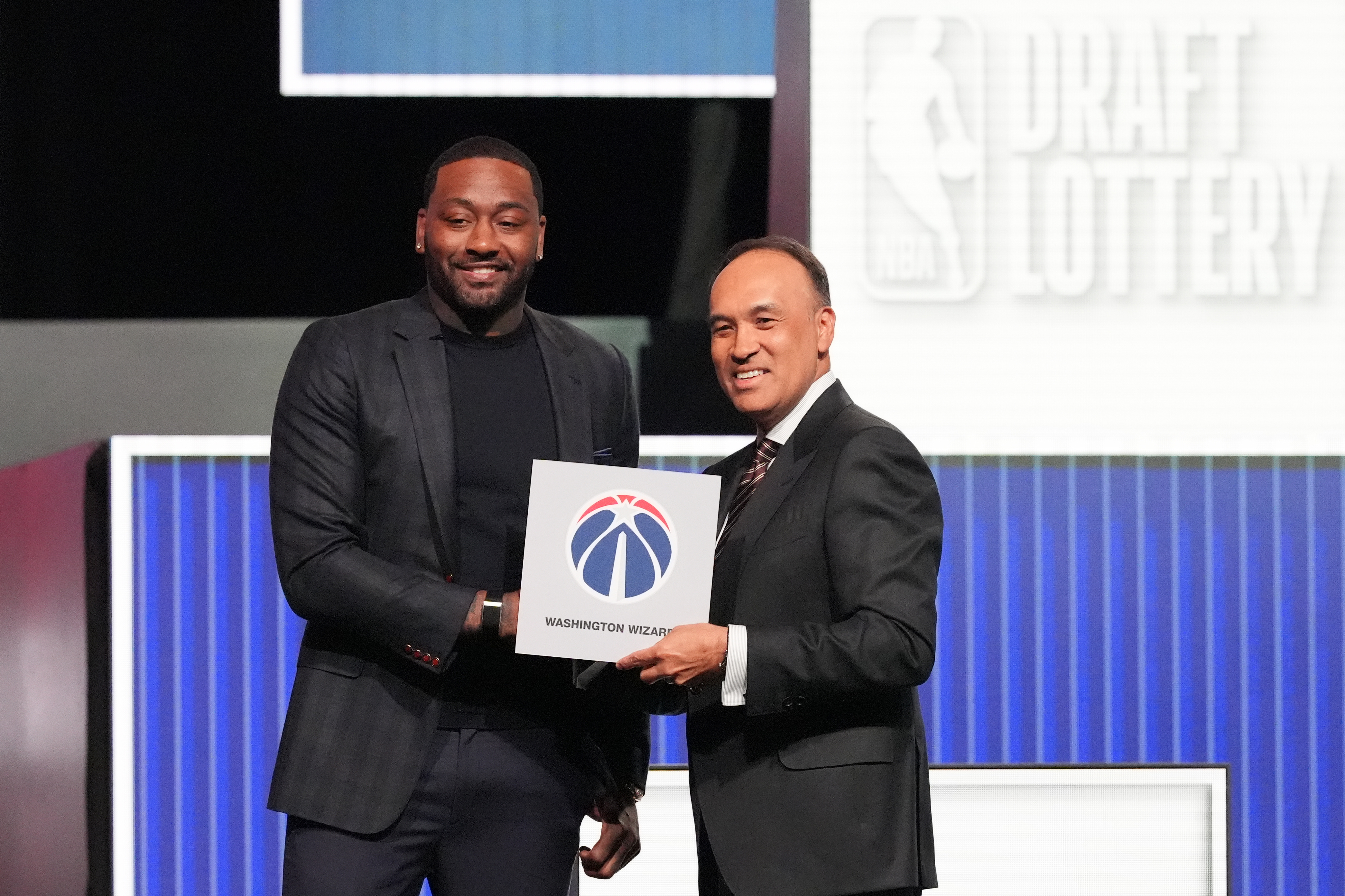 Washington Wizards' John Wall, left, and NBA Deputy Commissioner Mark Tatum, pose for photos after Tatum announced that the Wizards had won the first pick in the NBA basketball draft lottery in Chicago, Sunday, May 10, 2026. 