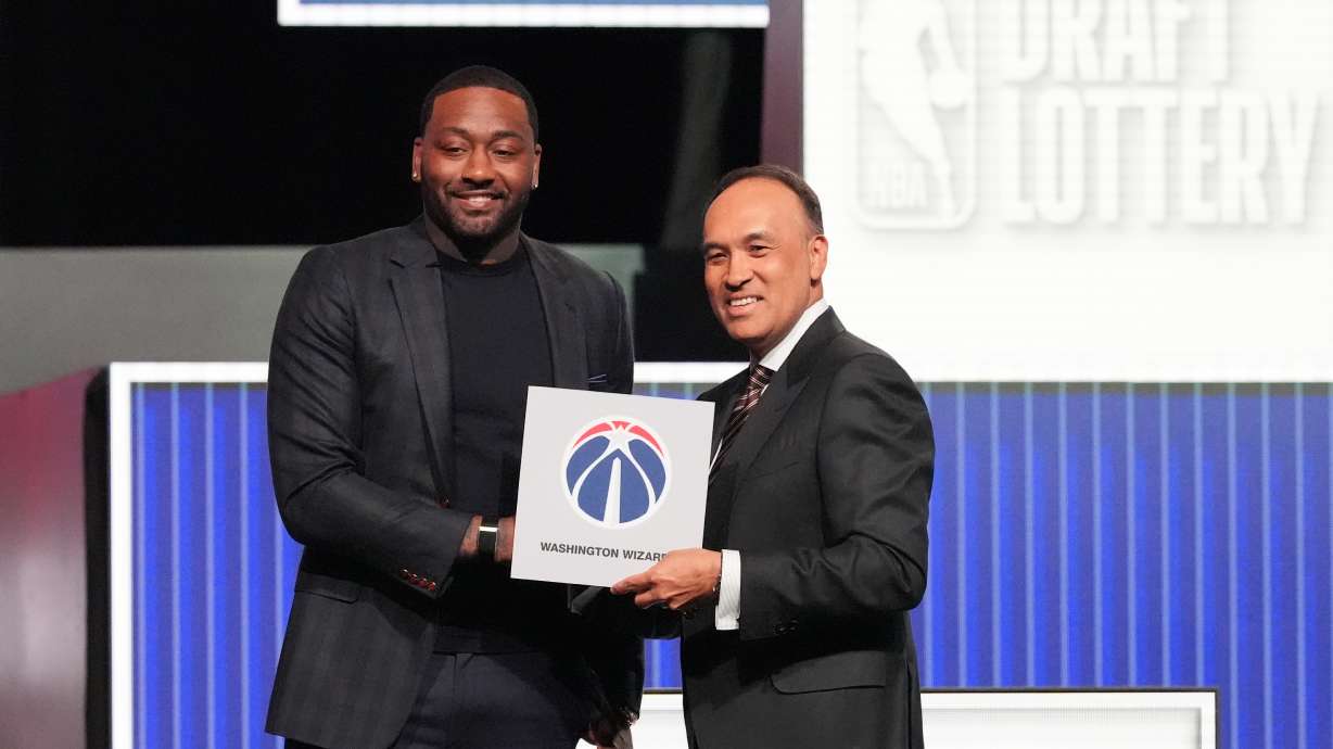 Washington Wizards' John Wall, left, and NBA Deputy Commissioner Mark Tatum, pose for photos after Tatum announced that the Wizards had won the first pick in the NBA basketball draft lottery in Chicago, Sunday, May 10, 2026.