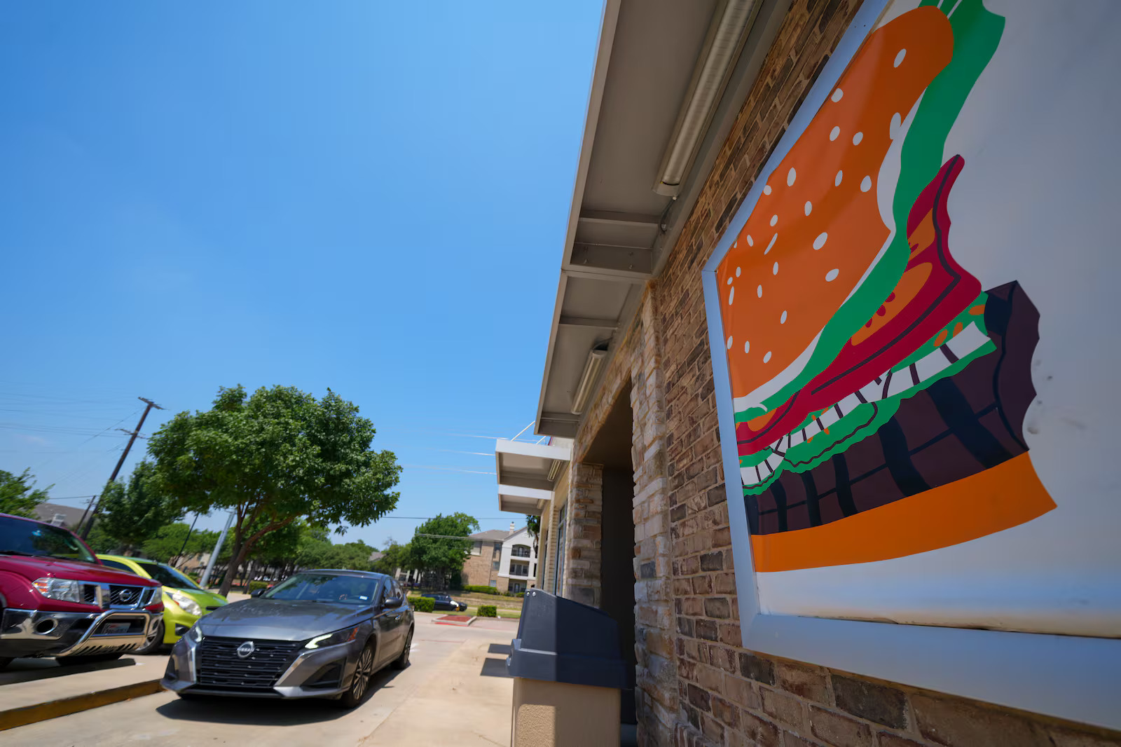 A vehicle enters the drive-thru of a Burger King restaurant, Aug. 5, in Garland, Texas. The chain is one of the many offering deals on National Burger Day.