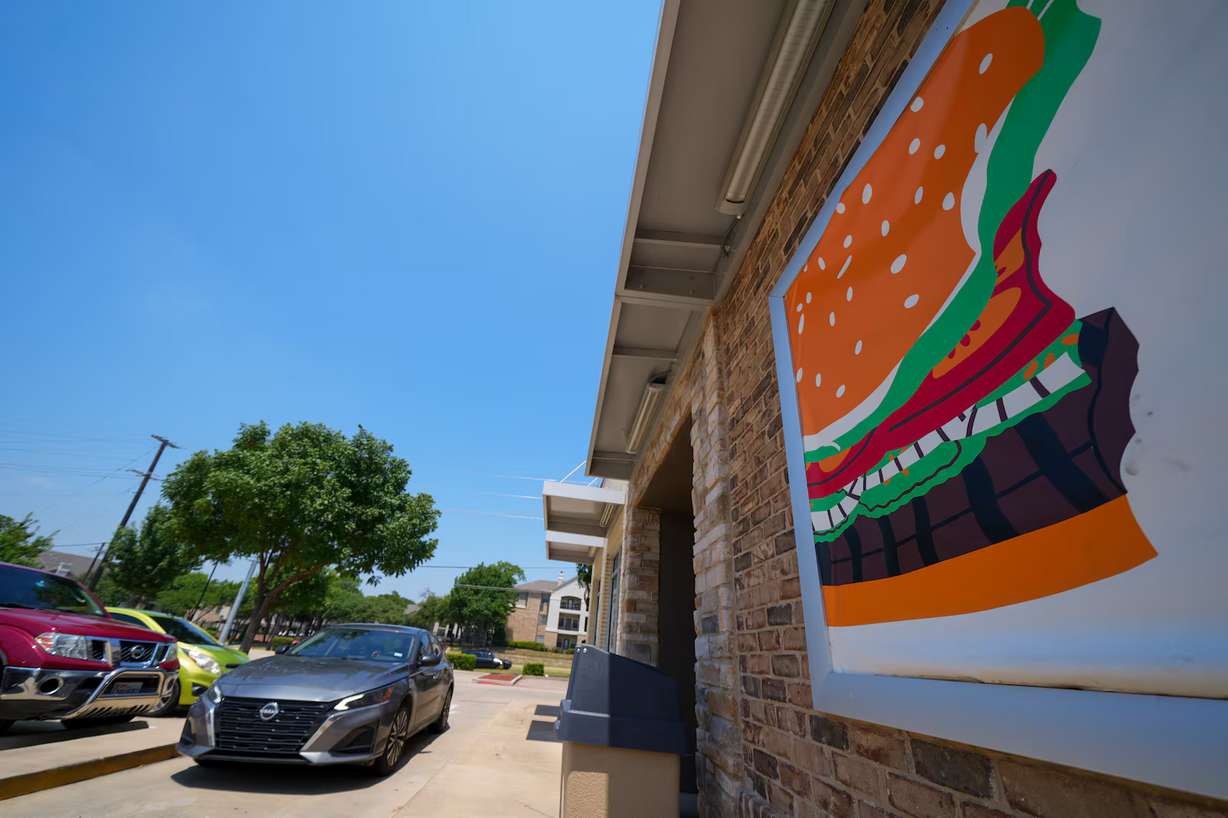 A vehicle enters the drive-thru of a Burger King restaurant, Aug. 5, in Garland, Texas. The chain is one of the many offering deals on National Burger Day.