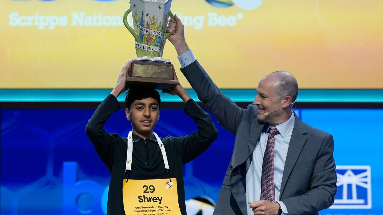 E.W. Scripps Company president and CEO Adam Symson, right, holds the trophy over winner of the 2026 Scripps National Spelling Bee, Shrey Parikh, 14, of Rancho Cucamonga, Calif., at DAR Constitution Hall, Thursday, May 28, 2026, in Washington.
