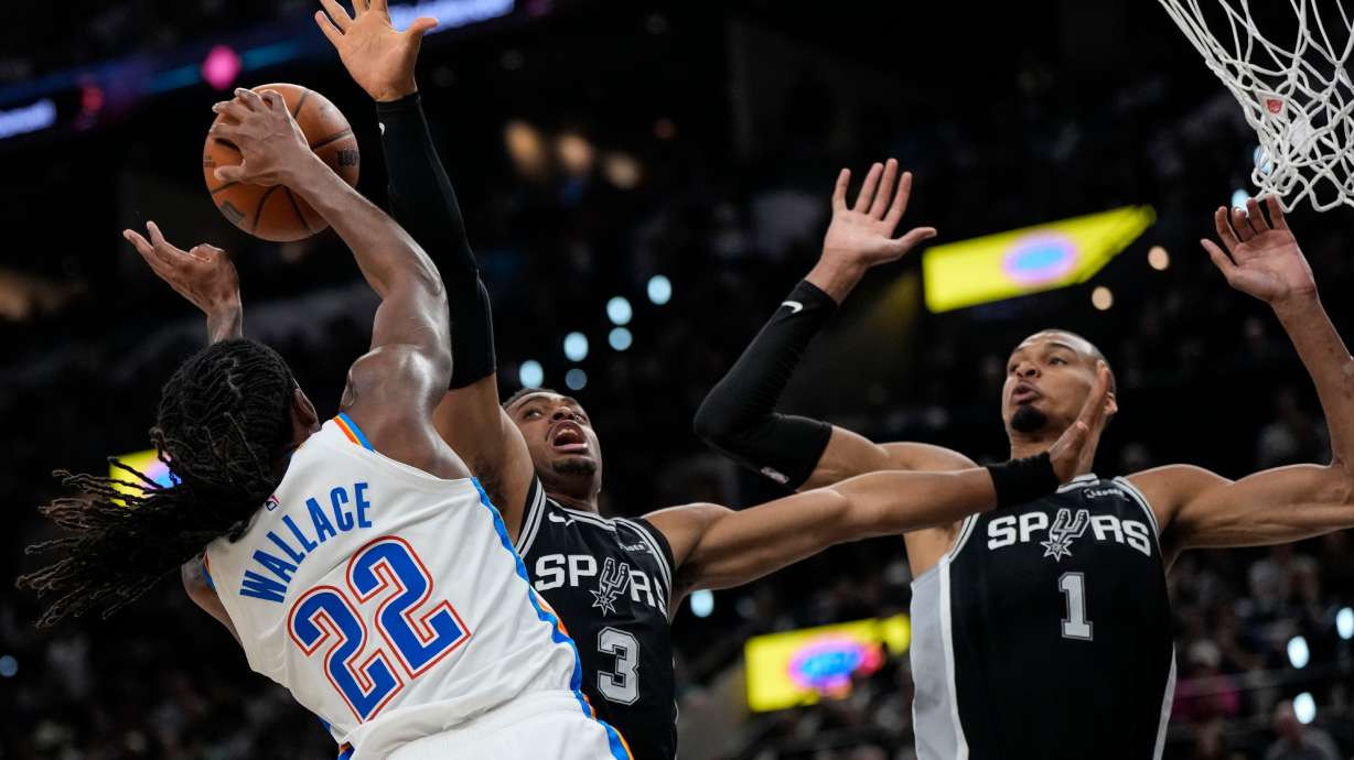 Oklahoma City Thunder guard Cason Wallace (22) shoots against San Antonio Spurs forward Keldon Johnson (3) in the second half of Game 6 in the Western Conference finals NBA basketball playoffs series, Thursday, May 28, 2026, in San Antonio.
