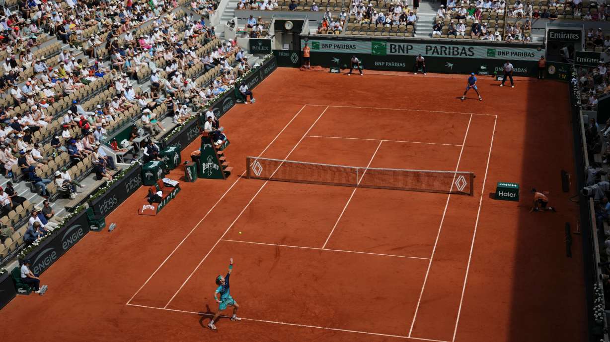 Andrey Rublev of Russia, bottom, serves to Nuno Borges of Portugal during their third round men's singles tennis match at the French Open tennis tournament in Paris, Friday, May 29, 2026.