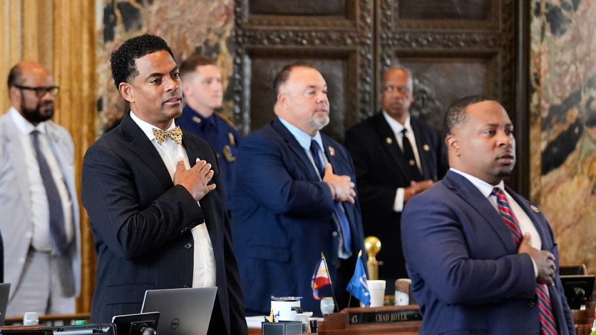 Louisiana Reps. Adrian Fisher, left, Chad Michael Boyer, and C. Travis Johnson, right, recite the pledge of allegiance prior to a vote on a redistricting plan in response to a U.S. Supreme Court ruling, in Baton Rouge, La., May 21.