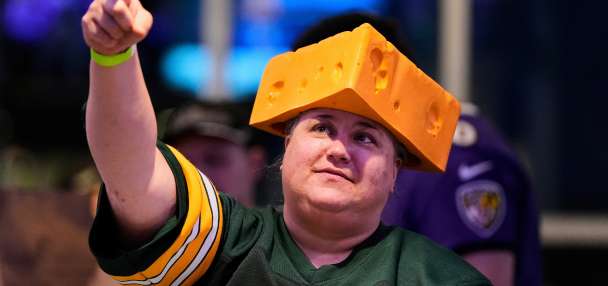 The cheesehead hat is a sunny nod to America's 'Hold my beer' exuberance