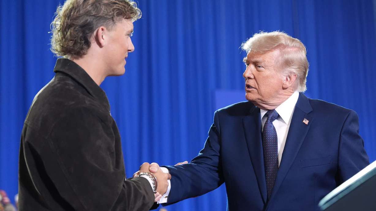 President Donald Trump shakes hands with New York Giants quarterback Jaxson Dart as he arrives to speak at Rockland Community College, Friday, May 22, 2026, in Suffern, N.Y.
