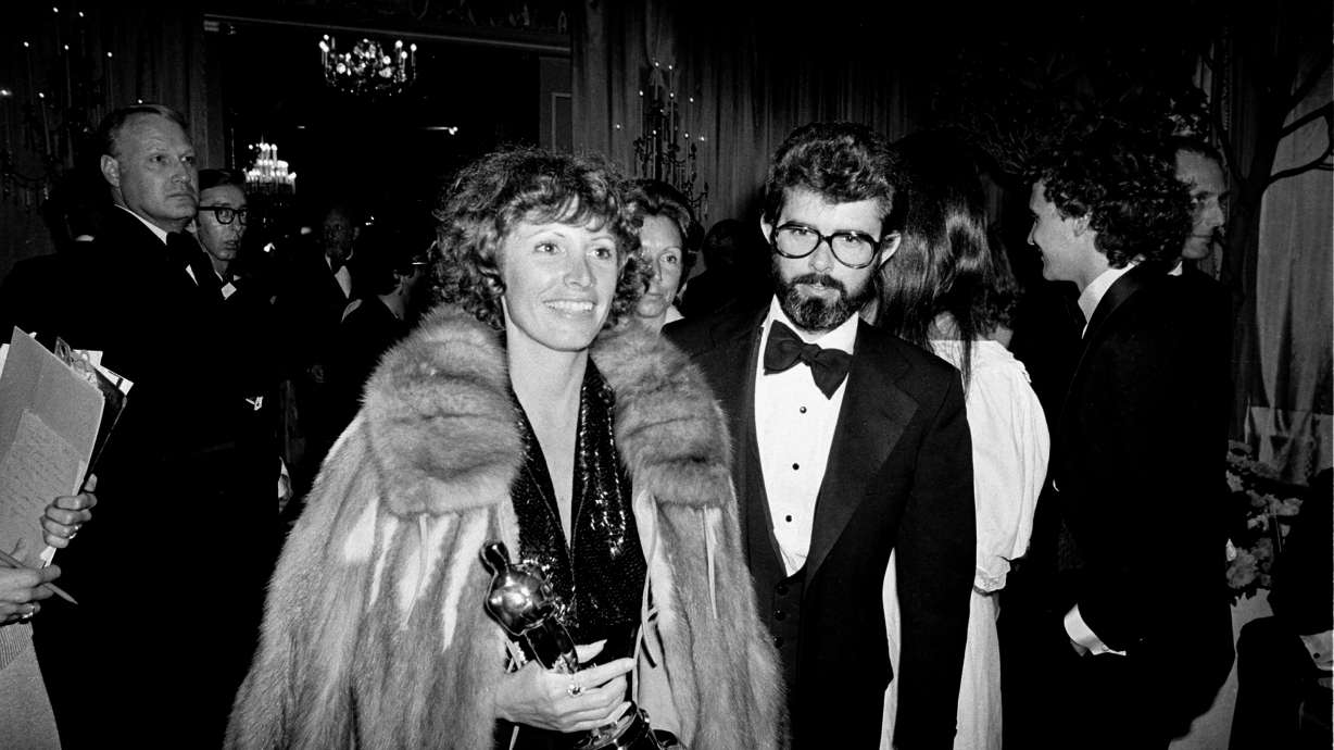 Marcia Lucas, wife of director George Lucas, right, carries her Oscar statuette as they arrive at a post Academy Awards party at the Beverly Hilton Hotel in Los Angeles, April 4, 1978.