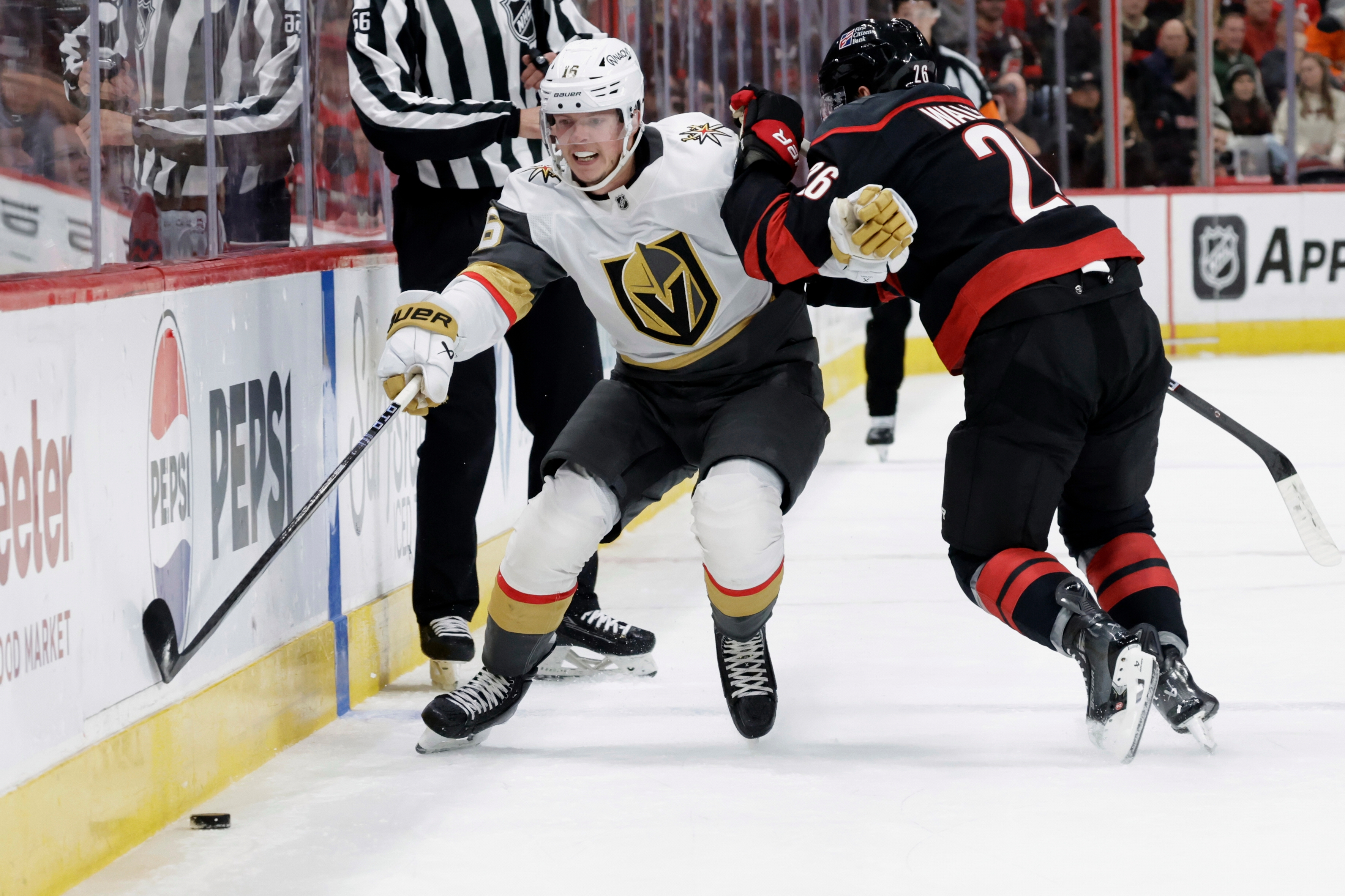 FILE - Vegas Golden Knights right wing Pavel Dorofeyev (16) and Carolina Hurricanes defenseman Sean Walker (26) vie for the puck during the first period of an NHL hockey game Oct. 28, 2025, in Raleigh, N.C. 