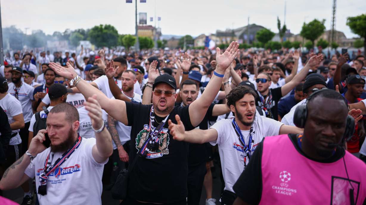 PSG supporters are accompanied by security ahead of the Champions League final soccer match between Paris Saint-Germain and Arsenal in Budapest, Hungary, Saturday, May 30, 2026.