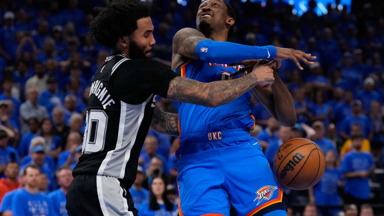 San Antonio Spurs forward Julian Champagnie (30) defends against Oklahoma City Thunder guard Jalen Williams (8) during overtime of Game 1 in a third-round NBA basketball playoffs series Monday, May 18, 2026, in Oklahoma City.