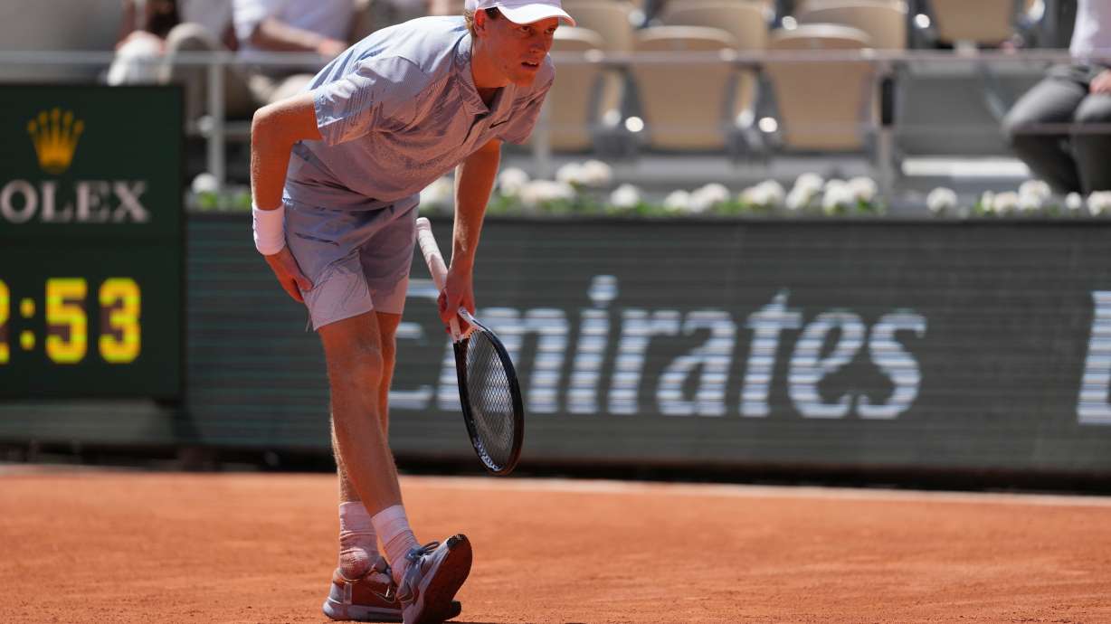 Jannik Sinner of Italy reacts as he feels unwell because of the heat during the second round men's singles tennis match against Juan Manuel Cerundolo of Argentina at the French Open tennis tournament in Paris, Thursday, May 28, 2026, as temperature rises up to 33 C (91 F).