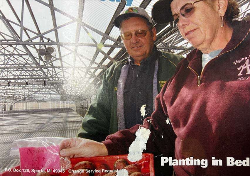 Clen and Emma Atchley working together in their greenhouse.