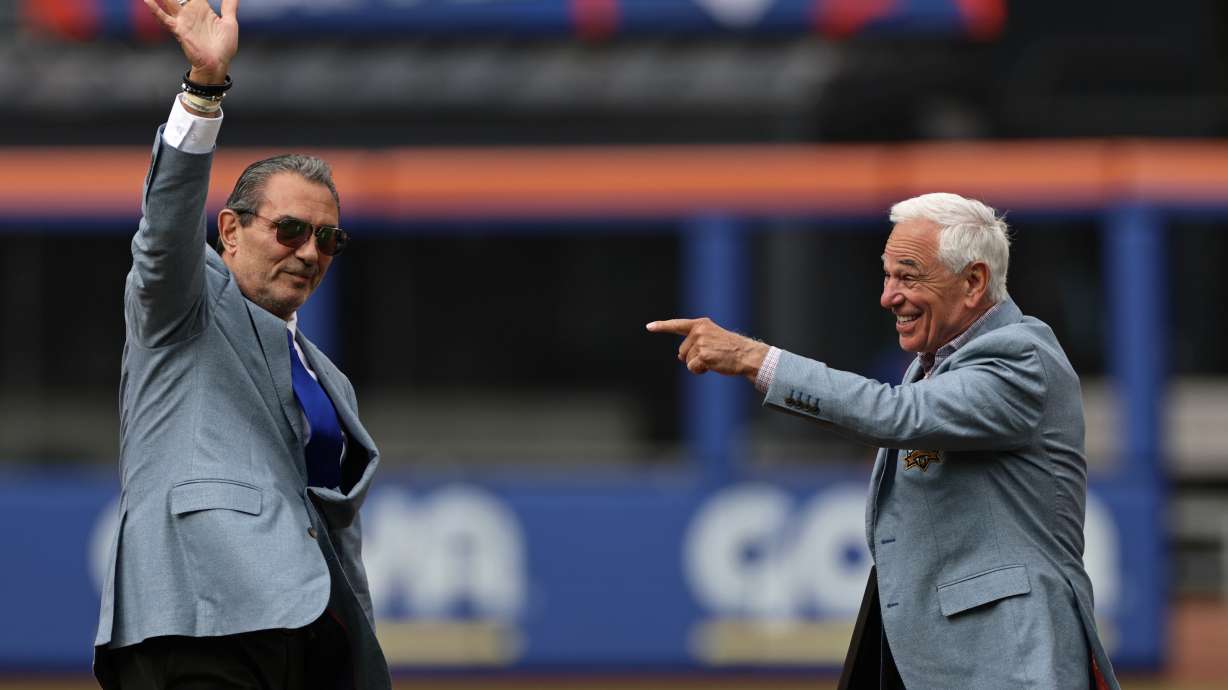 Lee Mazzilli, left, and Bobby Valentine wave and gesture during an induction ceremony into the New York Mets hall of fame before a baseball game against the Miami Marlins, Saturday, May 30, 2026, in New York.