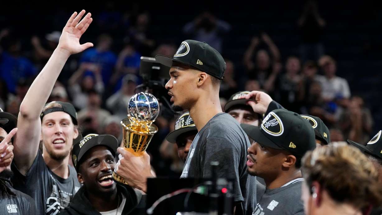 San Antonio Spurs forward Victor Wembanyama holds the MVP trophy as he celebrates with teammates after Game 7 of the Western Conference finals of the NBA basketball playoffs series win against the Oklahoma City Thunder, Saturday, May 30, 2026, in Oklahoma City.