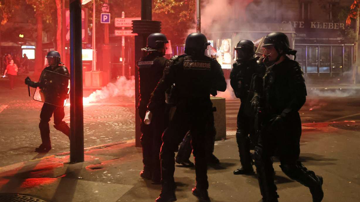 Police try to disperses PSG supporters who left off fireworks as they celebrate in Paris, Saturday, May 30, 2026 after the Champions League final soccer match between Paris Saint-Germain and Arsenal that was played in Budapest, PSG won the game.