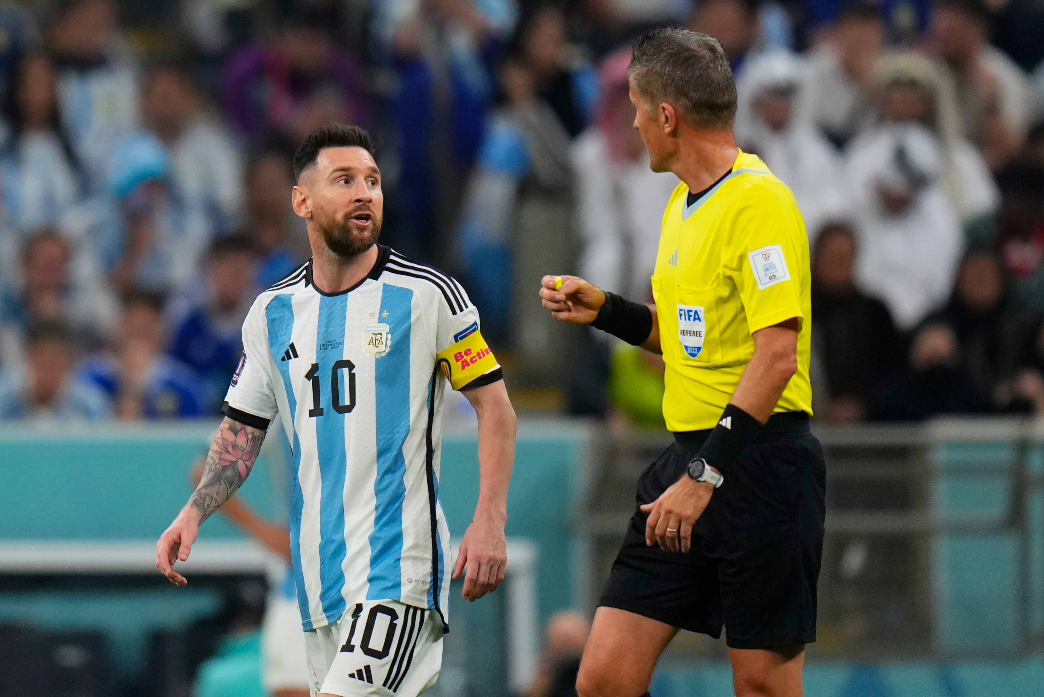 FILE - Referee Daniele Orsato talks to Argentina's Lionel Messi, left, during the World Cup semifinal soccer match between Argentina and Croatia at the Lusail Stadium in Lusail, Qatar, Dec. 13, 2022. 