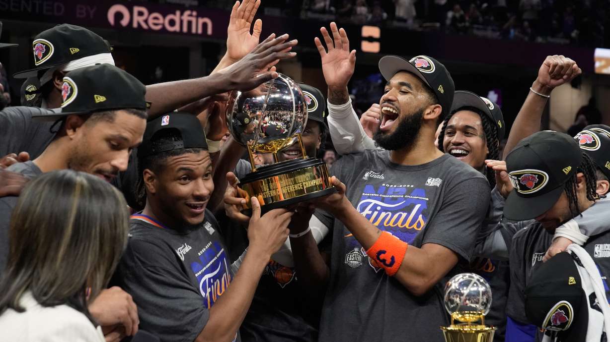 The New York Knicks hold the Eastern Conference Championship trophy after Game 4 in the Eastern Conference finals NBA basketball playoffs series against the Cleveland Cavaliers in Cleveland, Monday, May 25, 2026.