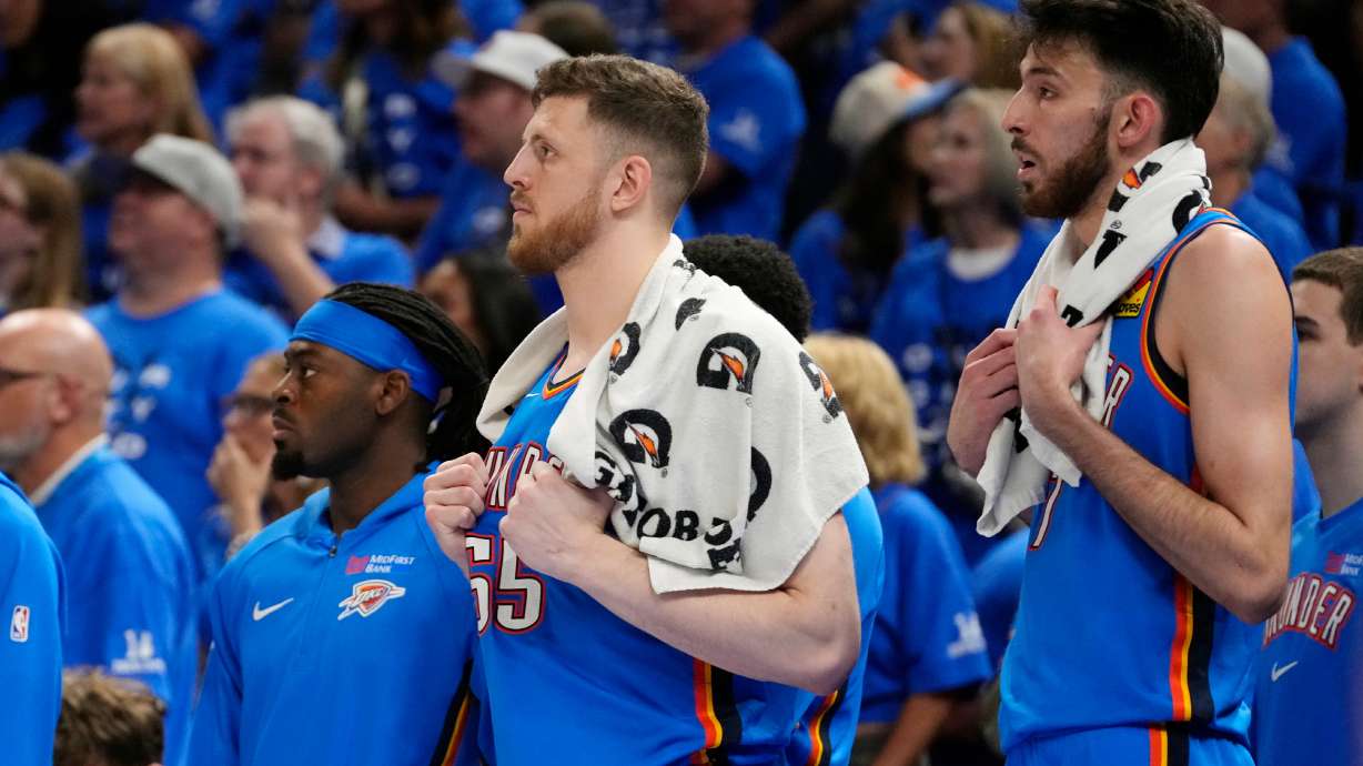 Oklahoma City Thunder guard Luguentz Dort, left, and Thunder centers Isaiah Hartenstein, center, and Chet Holmgren watch the action on the court from the team bench during the second half of Game 7 of the Western Conference finals of the NBA basketball playoffs series against the San Antonio Spurs, Saturday, May 30, 2026, in Oklahoma City.