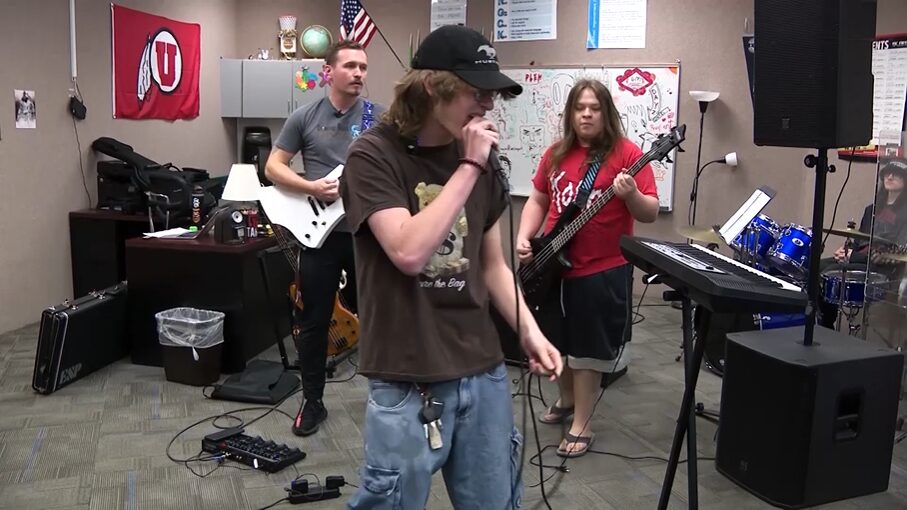 Two students are seen playing music alongside their teacher Brandon Lupus at Diamond Ridge High School.