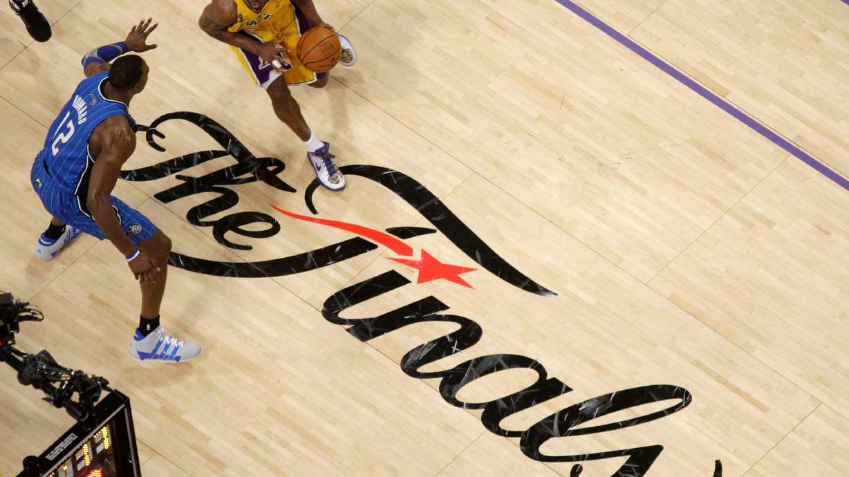 FILE - Los Angeles Lakers guard Kobe Bryant dribbles as Orlando Magic center Dwight Howard defends during the second half of Game 1 of the NBA basketball finals June 4, 2009, in Los Angeles.