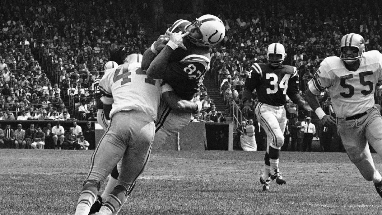 FILE - In this Sept. 30, 1962, file photo, Baltimore Colts end Raymond Berry snags a pass from quarterback John Unitas for 5-yard gain against the Detroit Lions in a football game in Baltimore. Lions' Dick LeBeau (44) makes the tackle.