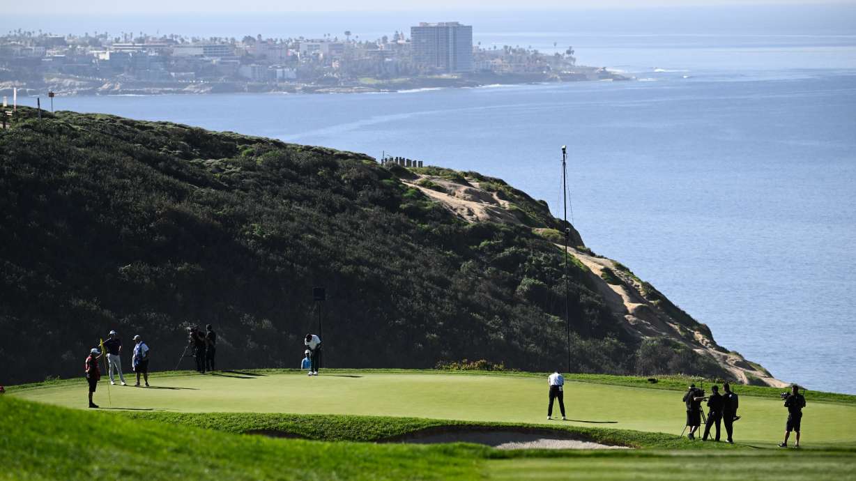 FILE - Justin Rose, of England, putts on the third green of the South Course at Torrey Pines during the final round of the Farmers Insurance Open golf tournament, Feb. 1, 2026, in San Diego.