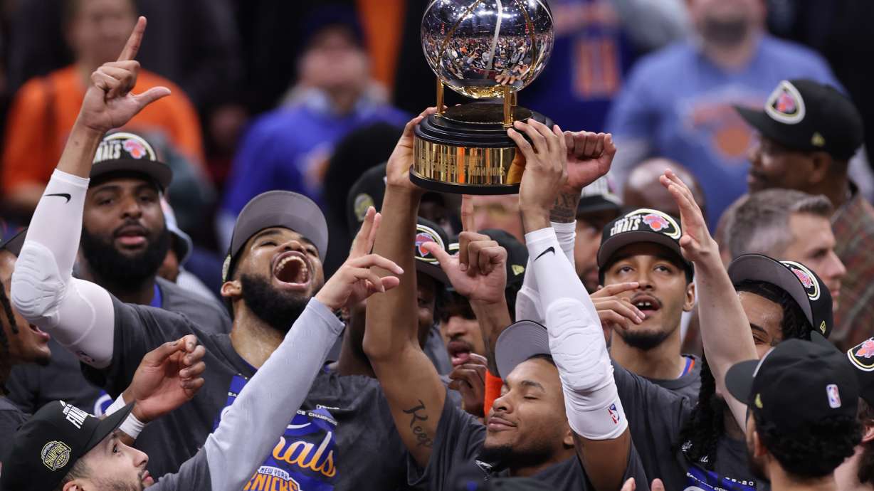 The New York Knicks hold the Eastern Conference Championship trophy after Game 4 in the Eastern Conference finals NBA basketball playoffs series against the Cleveland Cavaliers in Cleveland, Monday, May 25, 2026.