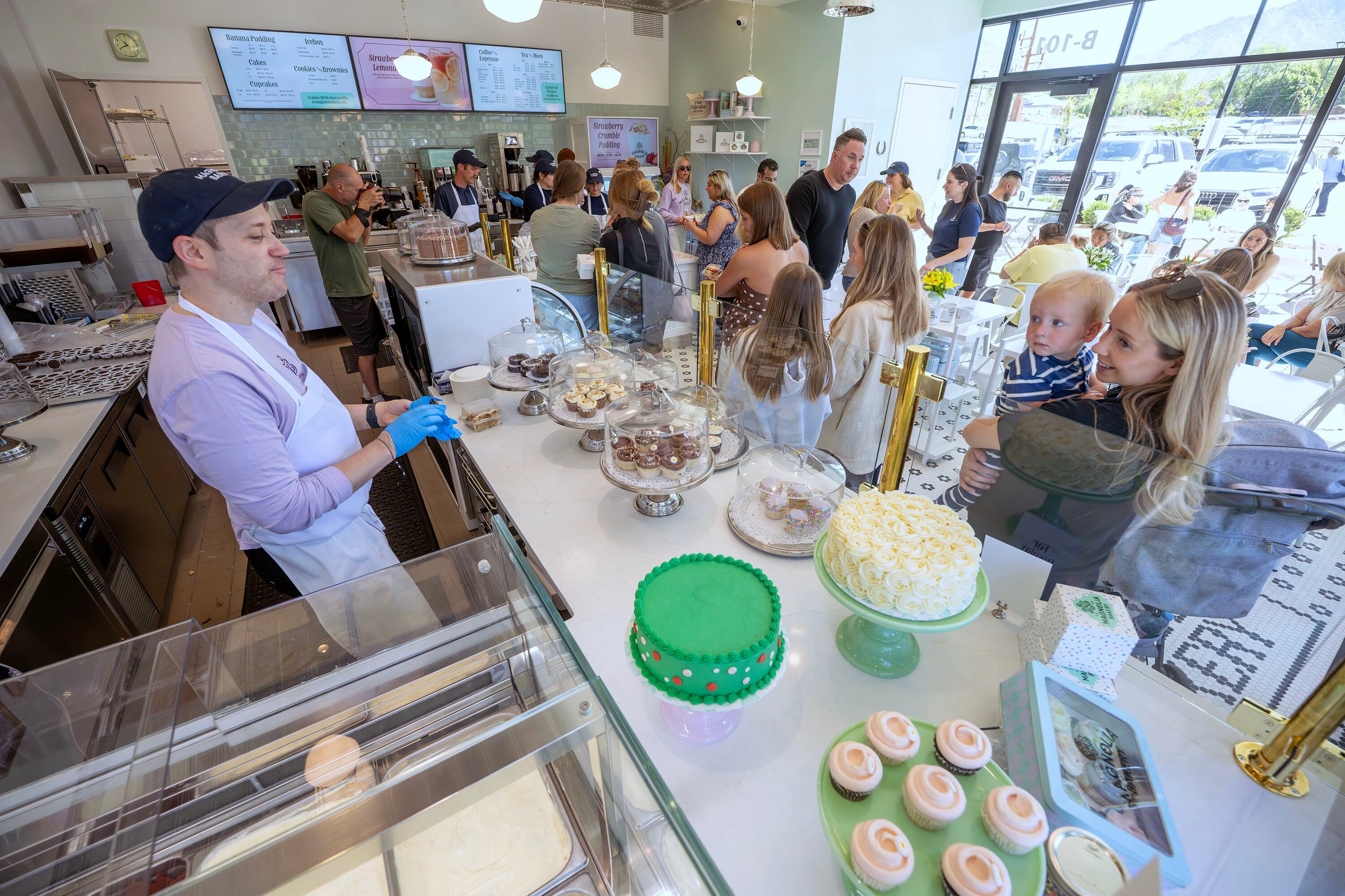 Customers purchase items as Magnolia Bakery opens in Holladay on Monday.