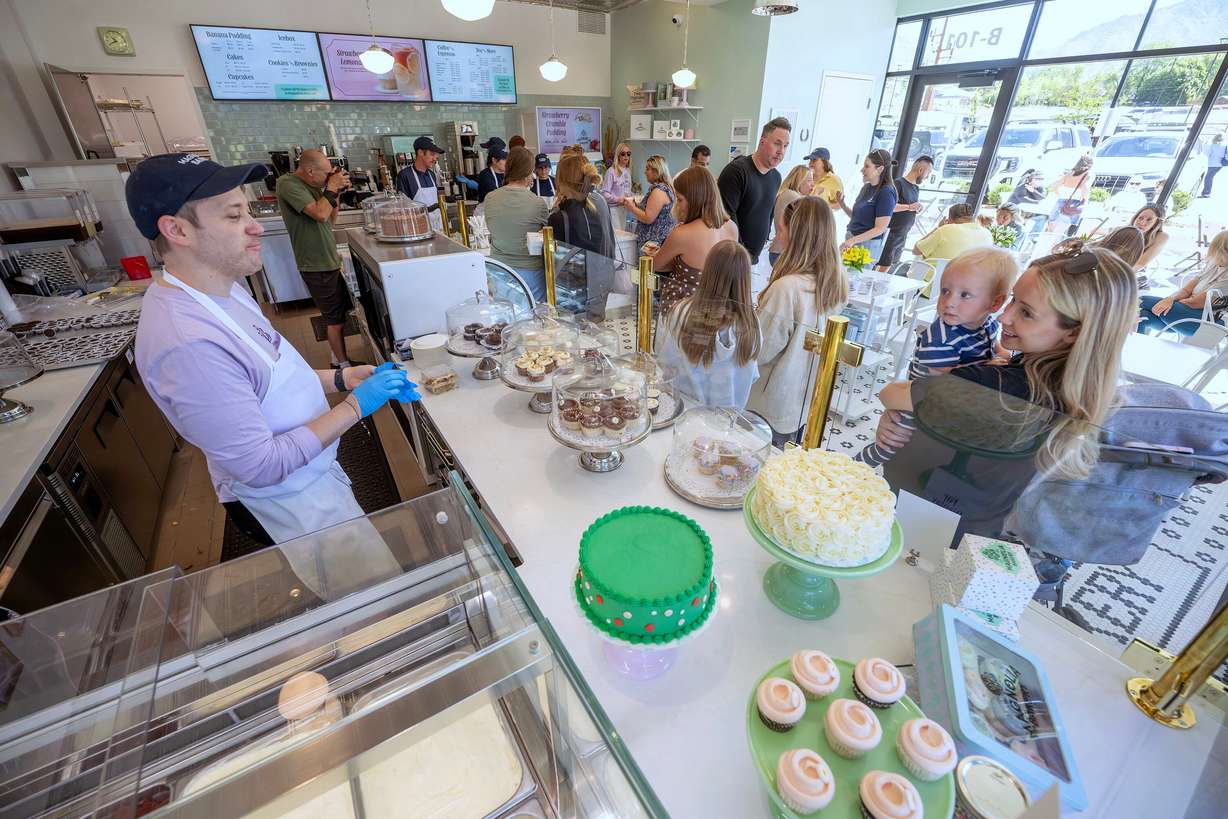 Customers purchase items as Magnolia Bakery opens in Holladay on Monday.