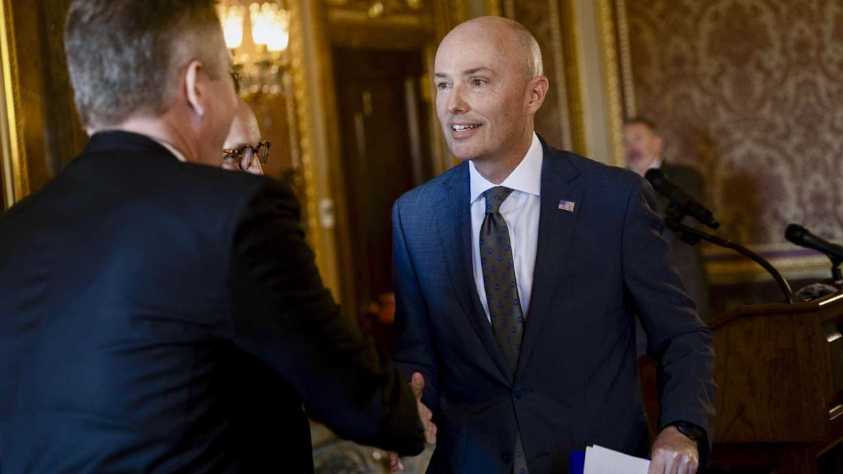 Gov. Spencer Cox shakes hands with Jay Jorgensen and Stephen Dent after announcing them as two new appointments to the Utah Supreme Court at the Capitol in Salt Lake City on Tuesday.
