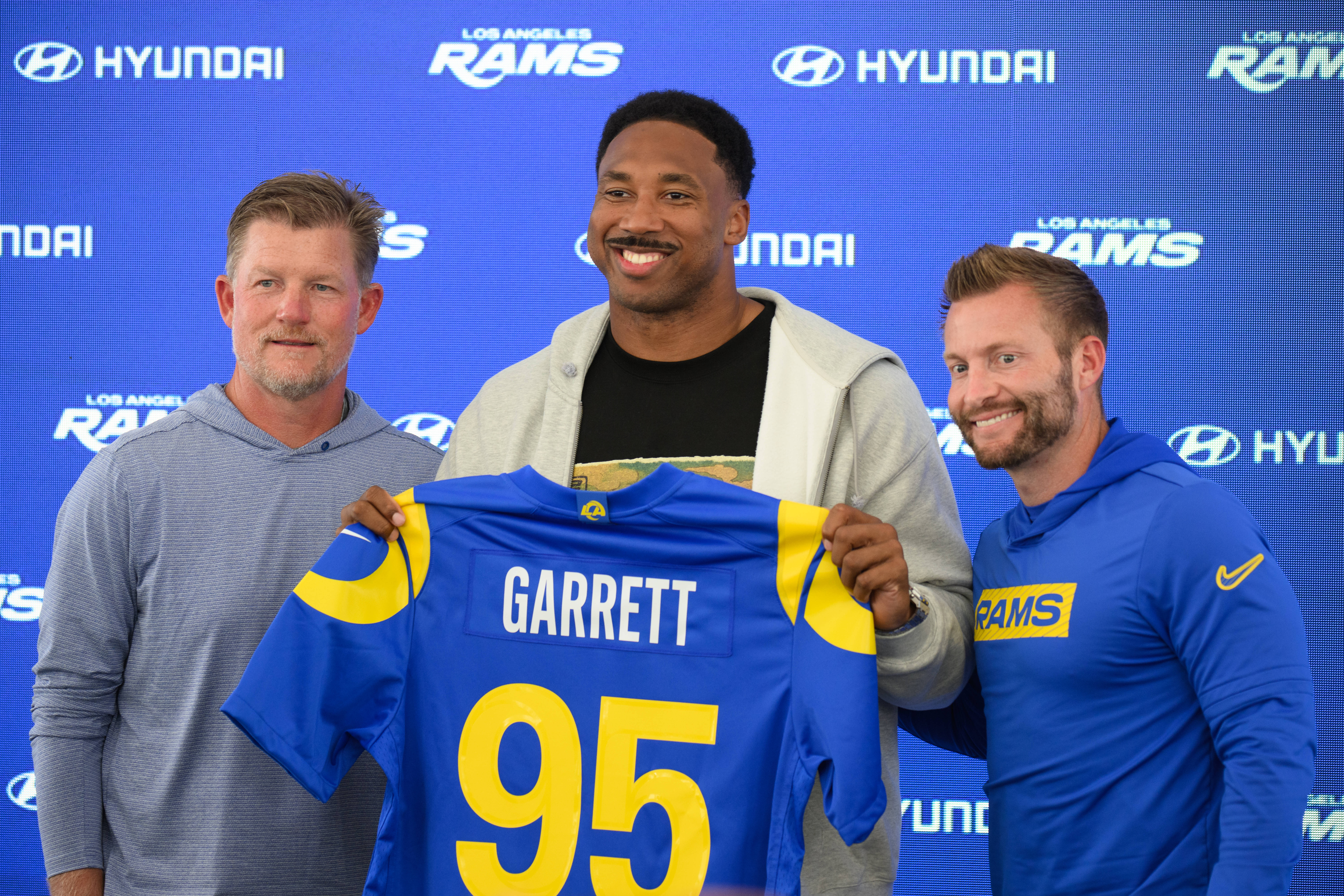 From left, Los Angeles Rams general manager Les Snead, left, defensive end Myles Garrett, and head coach Sean McVay pose for a photo during a press conference following the NFL football team's practice, Tuesday, June 2, 2026, in Woodland Hills, Calif. 