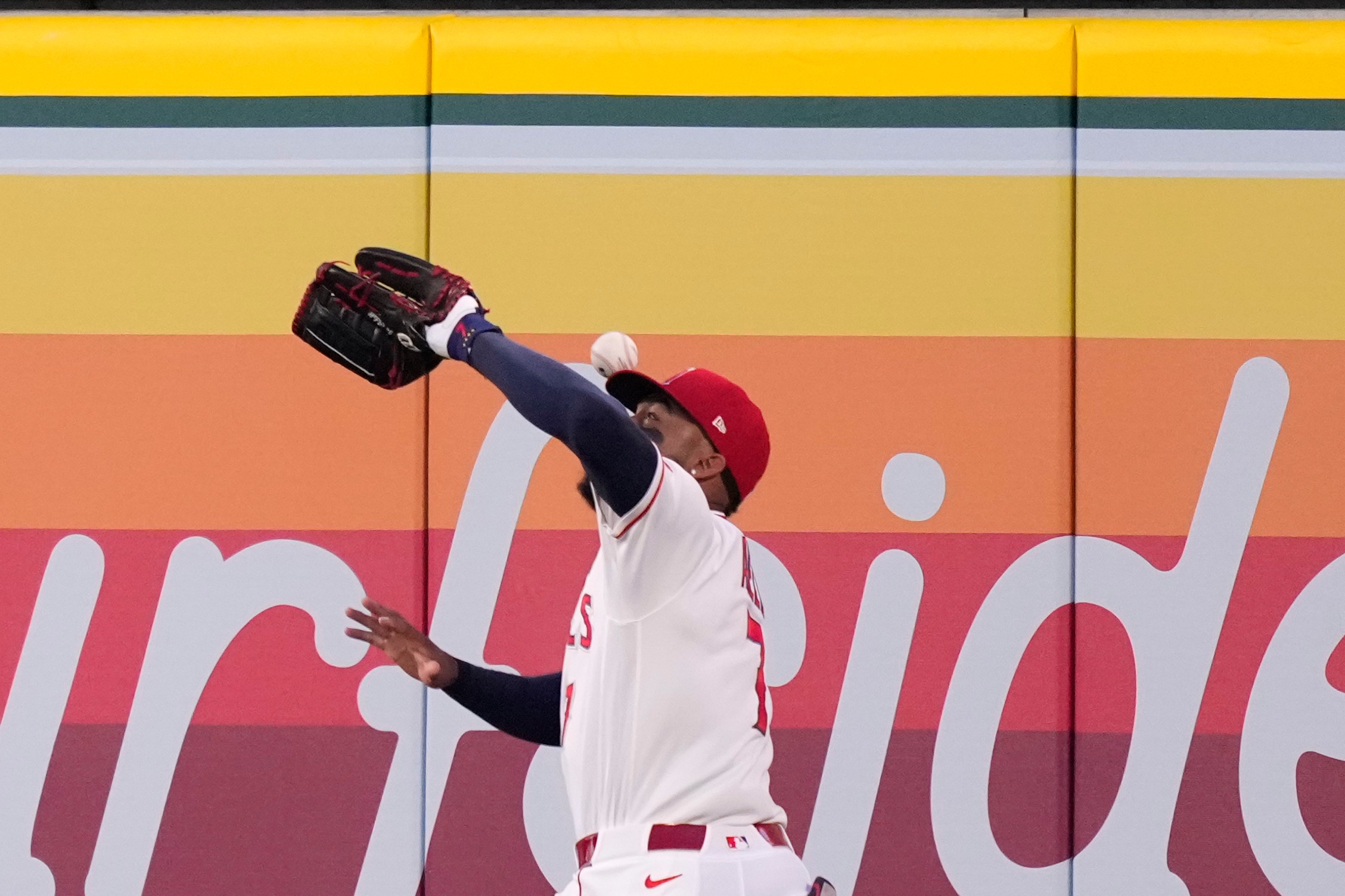 Los Angeles Angels right fielder Jo Adell misplays a ball hit by Colorado Rockies' TJ Rumfield that hit him in the head and then bounced out for a solo home run during the fourth inning of a baseball game Tuesday, June 2, 2026, in Anaheim, Calif. 